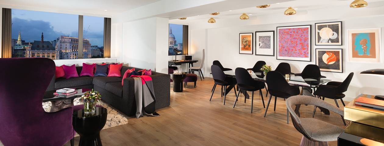 Spacious and very modern hotel apartment interior with contemporary furnishings and a large window view to Washington DC.