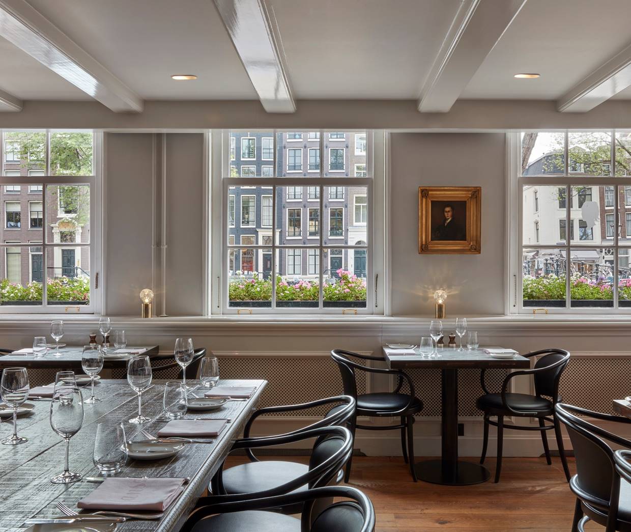 An elegant restaurant interior with neatly arranged tables, stylish chairs, and a cozy ambiance.