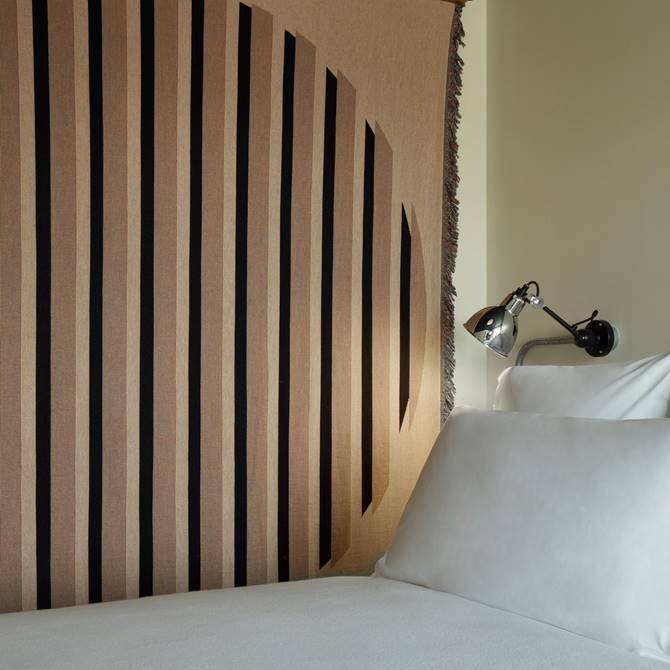 A stylish bedroom with a large, comfortable bed, modern decor, and soft lighting for a cozy atmosphere.