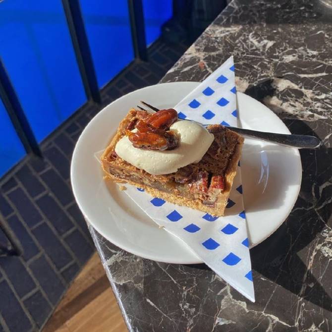 A slice of cake on a plate accompanied by a scoop of ice cream, creating a delightful dessert presentation.
