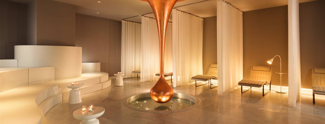 Spa area with a tranquil atmosphere, featuring massage tables and relaxing ambient lighting.