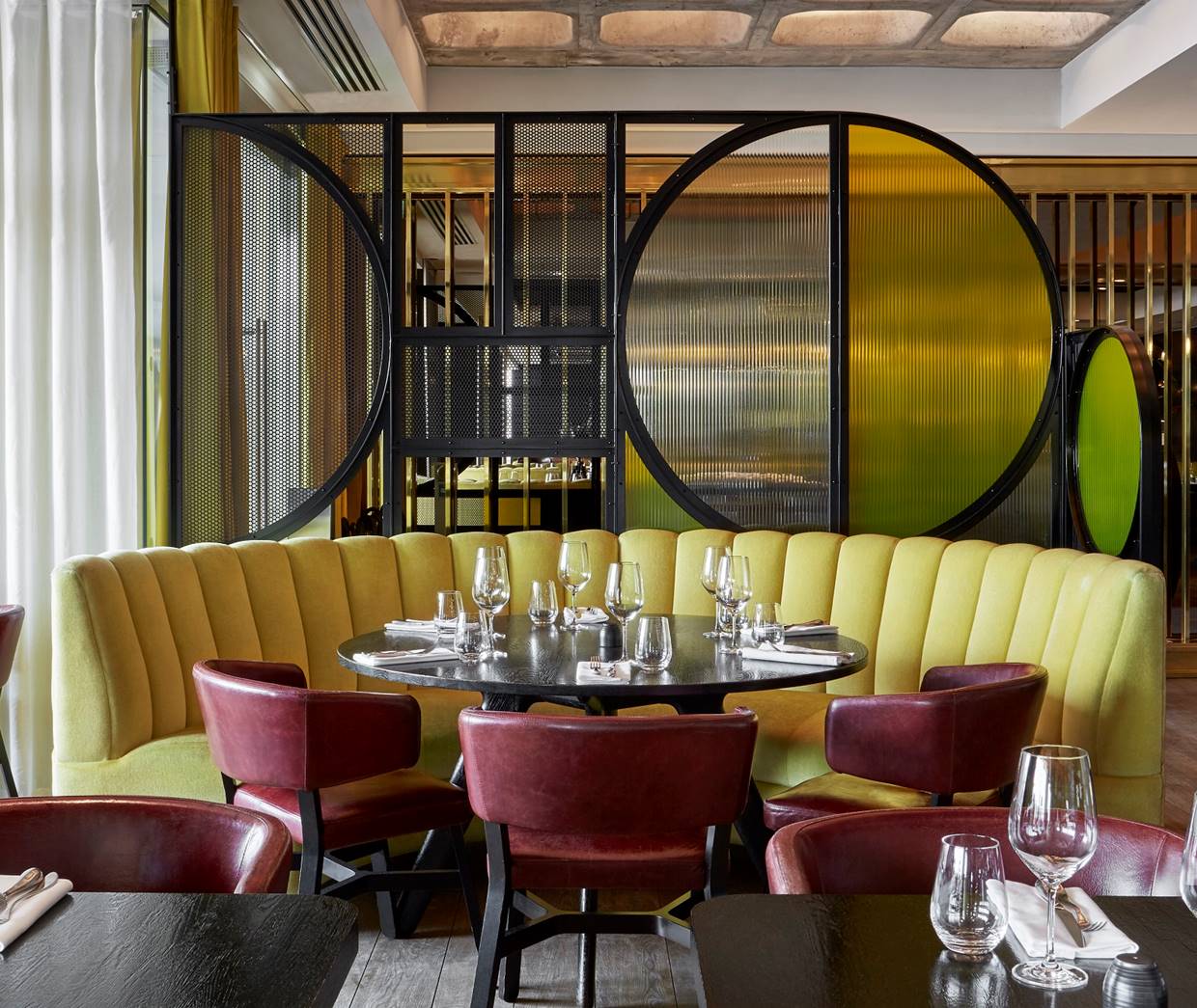 Restaurant interior at Sea Containers London with elegant dining tables, ambient lighting, and a welcoming atmosphere.