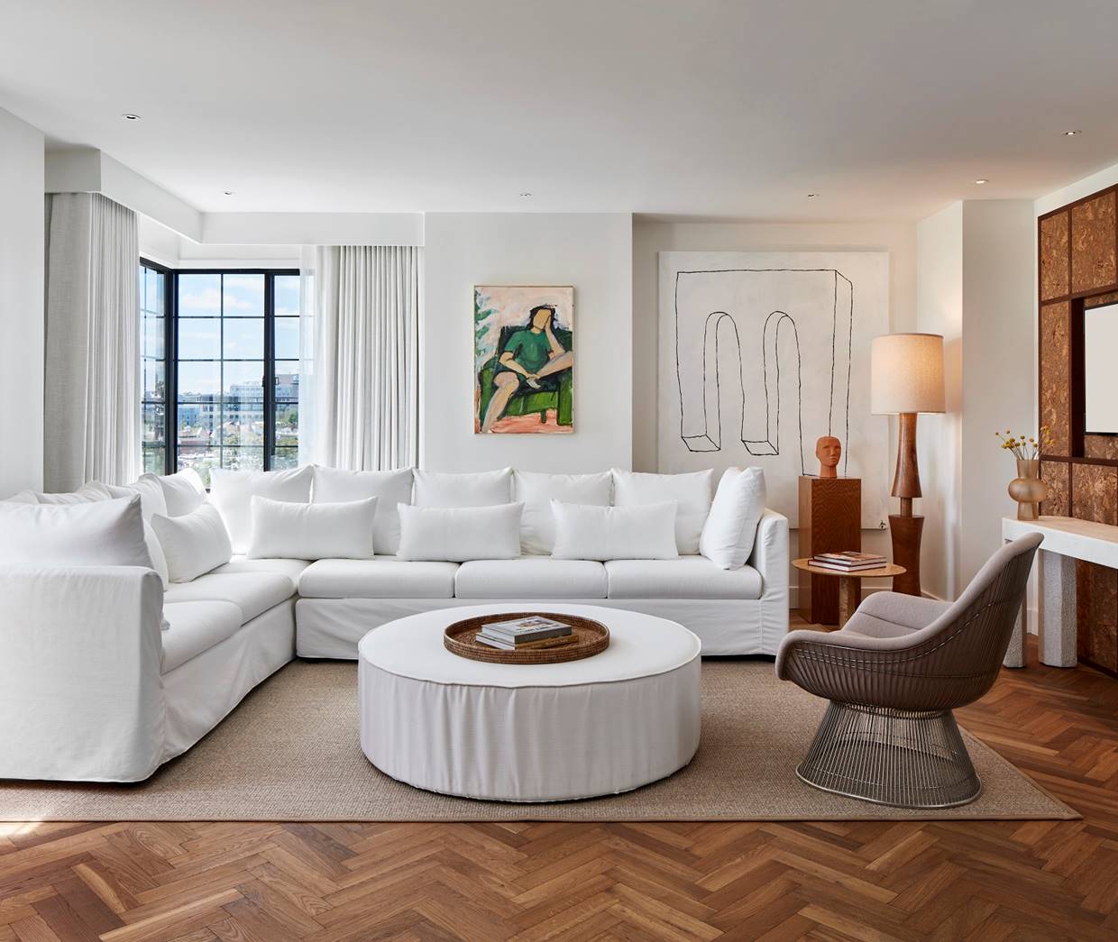 A luxurious living room with modern furnishings, artistic decor, and a spacious layout.