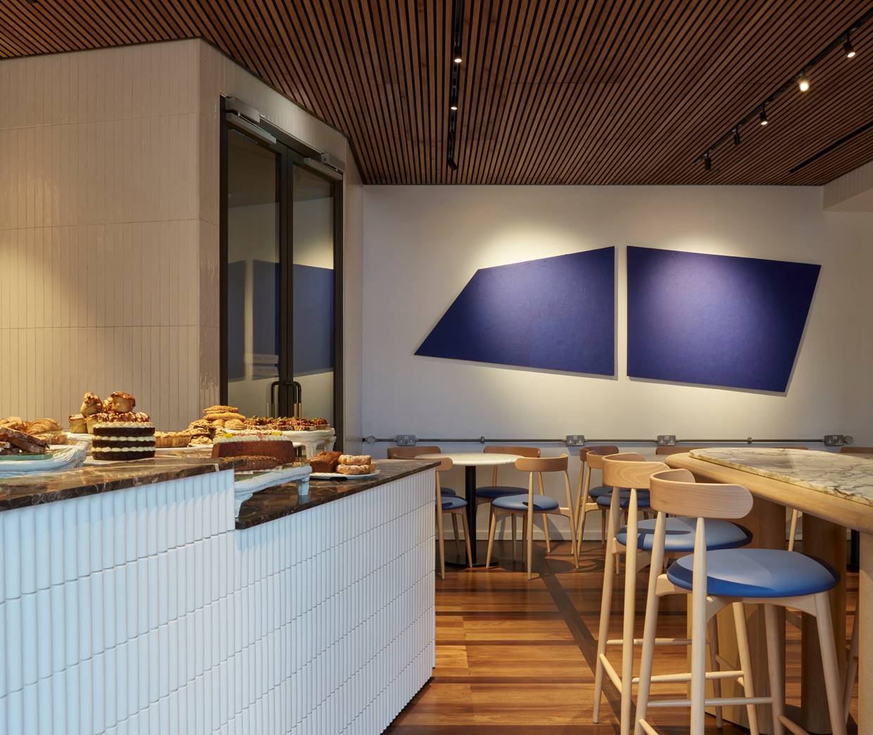 A contemporary restaurant featuring blue and white walls, creating a fresh and inviting dining atmosphere.