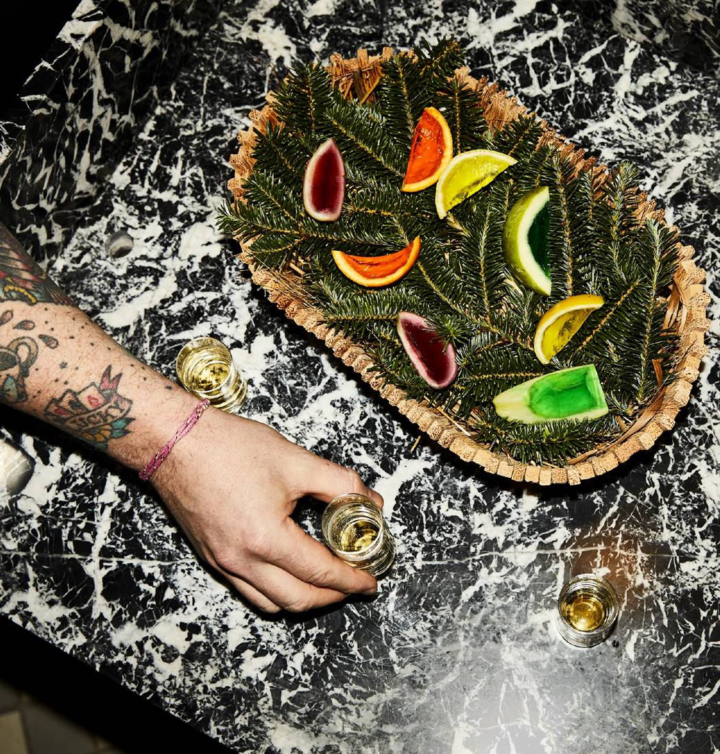Close-up of a colorful jello fruit basket, artistically arranged in basket with pine decoration.