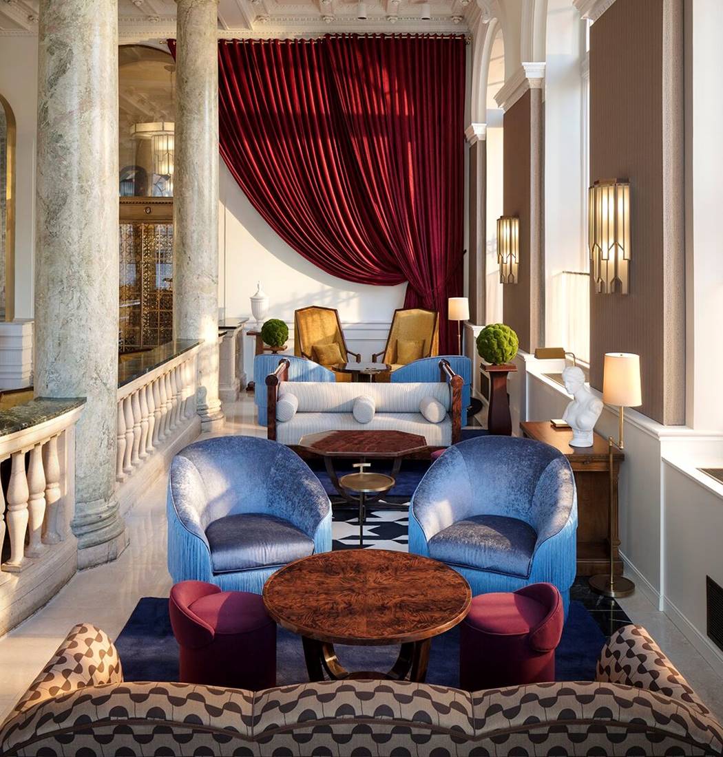 Luxurious hotel lounge with rich velvet curtains, elegant seating, and a blend of classic and contemporary decor.