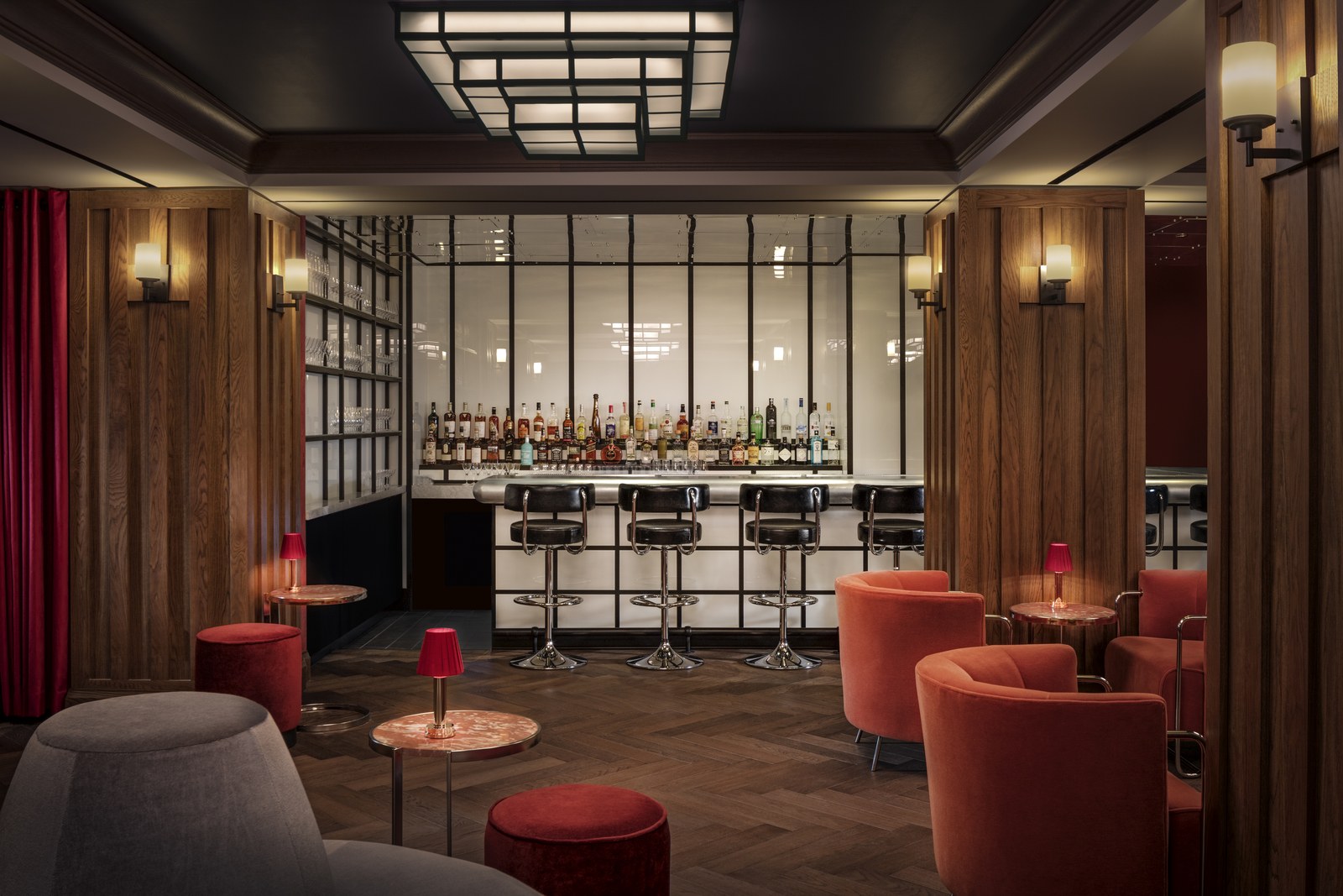 Elegant, modern bar interior at Silver Lyan with sleek black stools, a fully stocked bar, and ambient lighting.