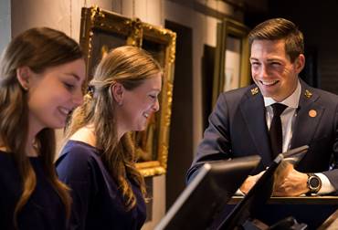 Recruitment photo shoot at Pulitzer Amsterdam, showcasing three staff members with warm smiles.
