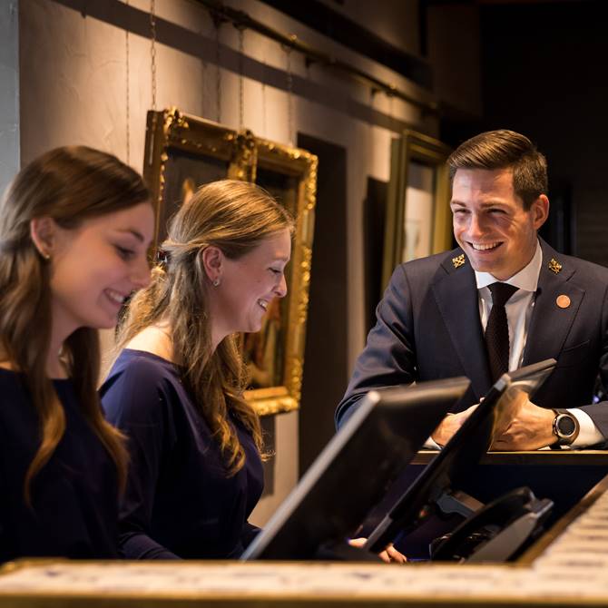 Recruitment photo shoot at Pulitzer Amsterdam, showcasing three staff members with warm smiles.