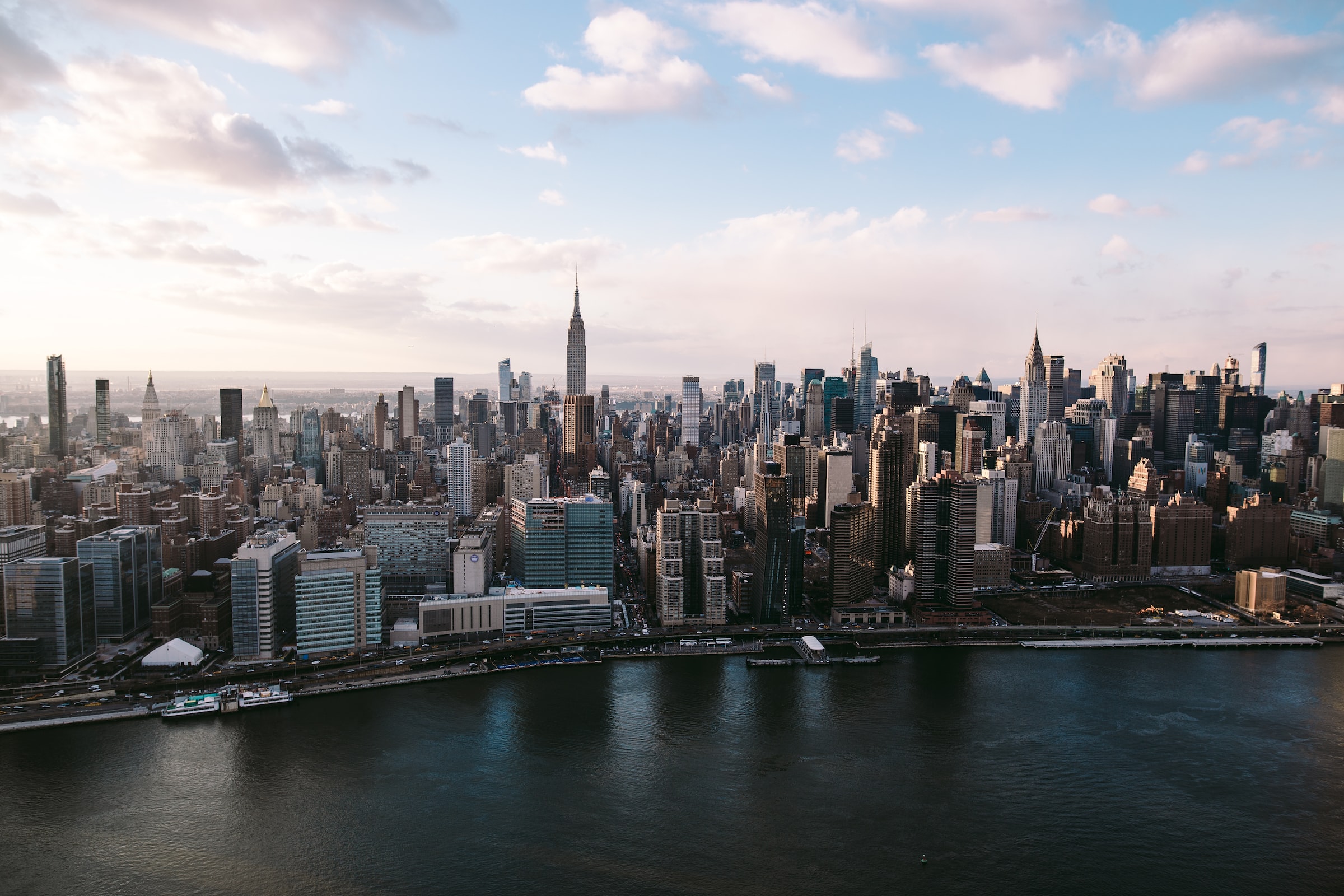 Panoramic skyline view of Manhattan with the Empire State Building in the center.