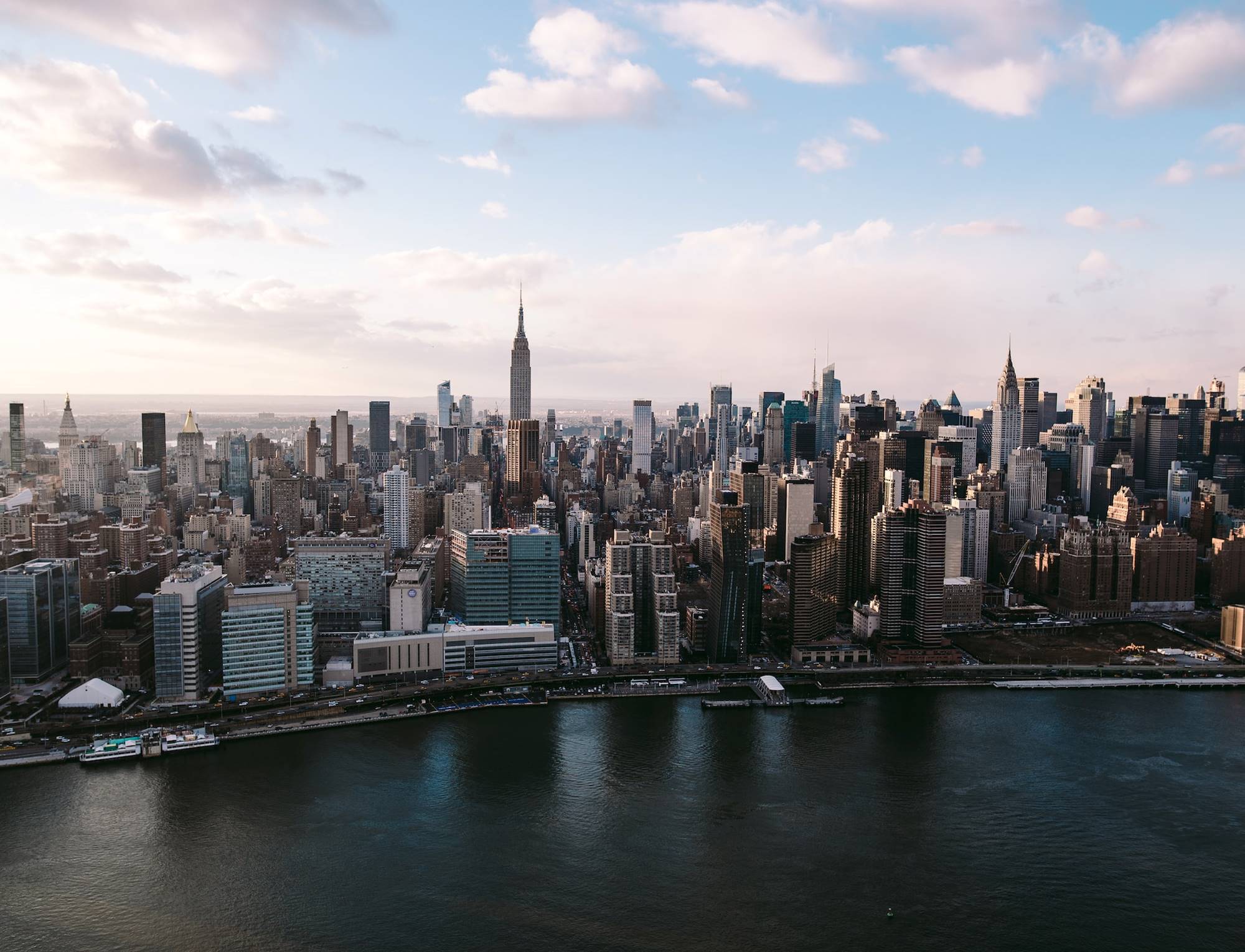 Panoramic skyline view of Manhattan with the Empire State Building in the center.